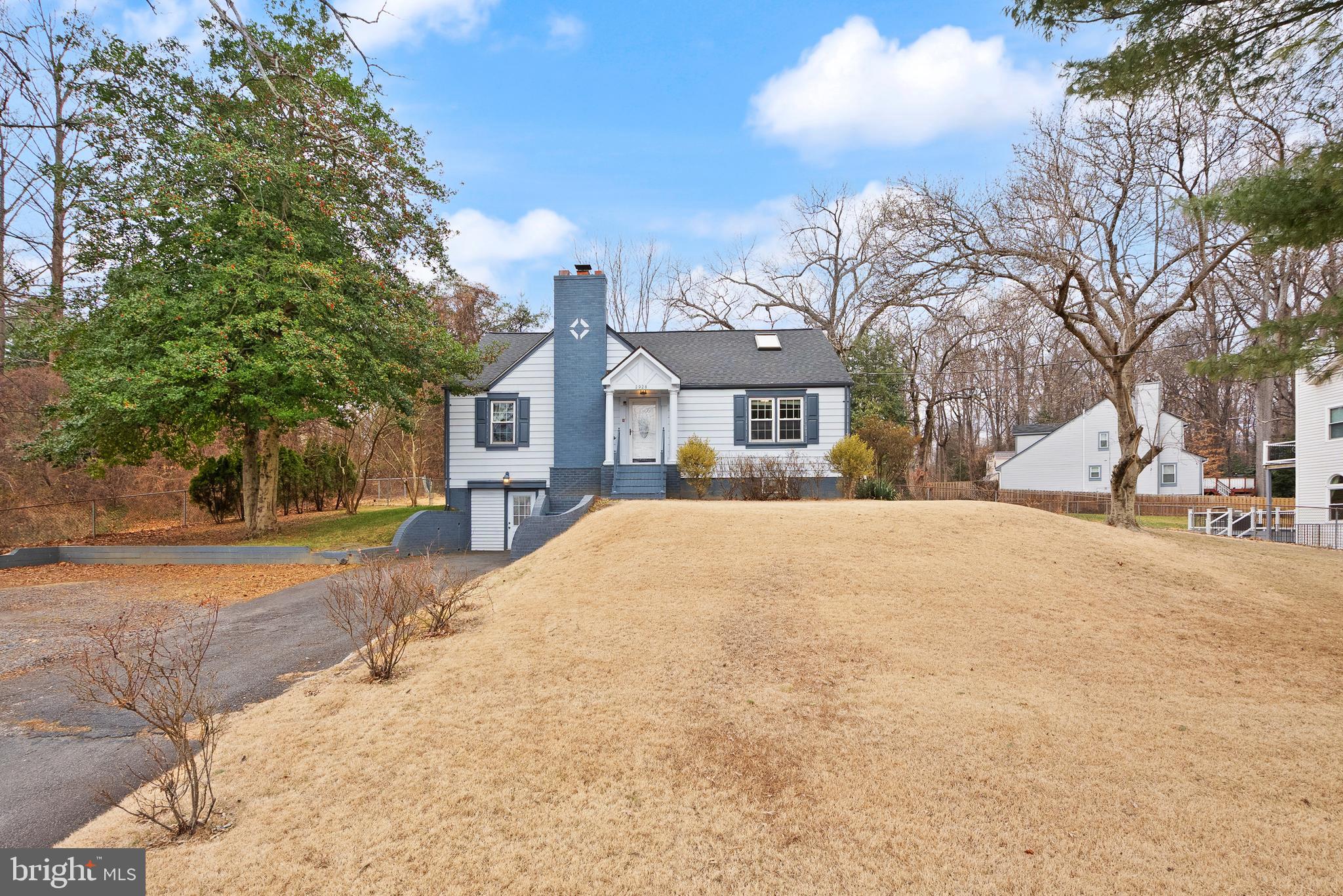 2928 Hunter Road Fairfax, VA 22031 - Photo 2 of 73 a view of a white house with a large tree in front of it