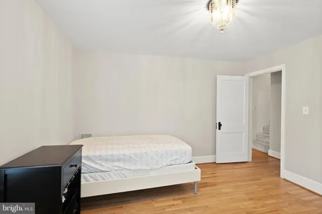 an empty room with windows and refrigerator