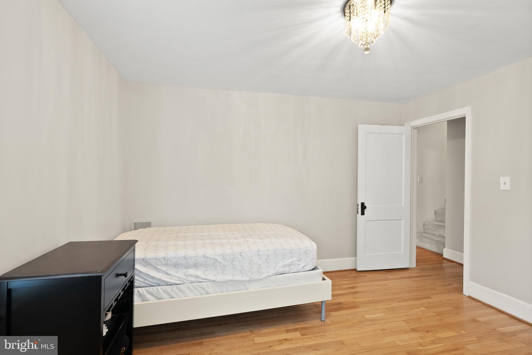 2928 Hunter Road Fairfax, VA 22031 - Photo 35 of 73 a bedroom with a bed and a chandelier