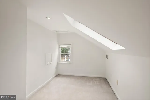 a view of a hallway and a livingroom with furniture