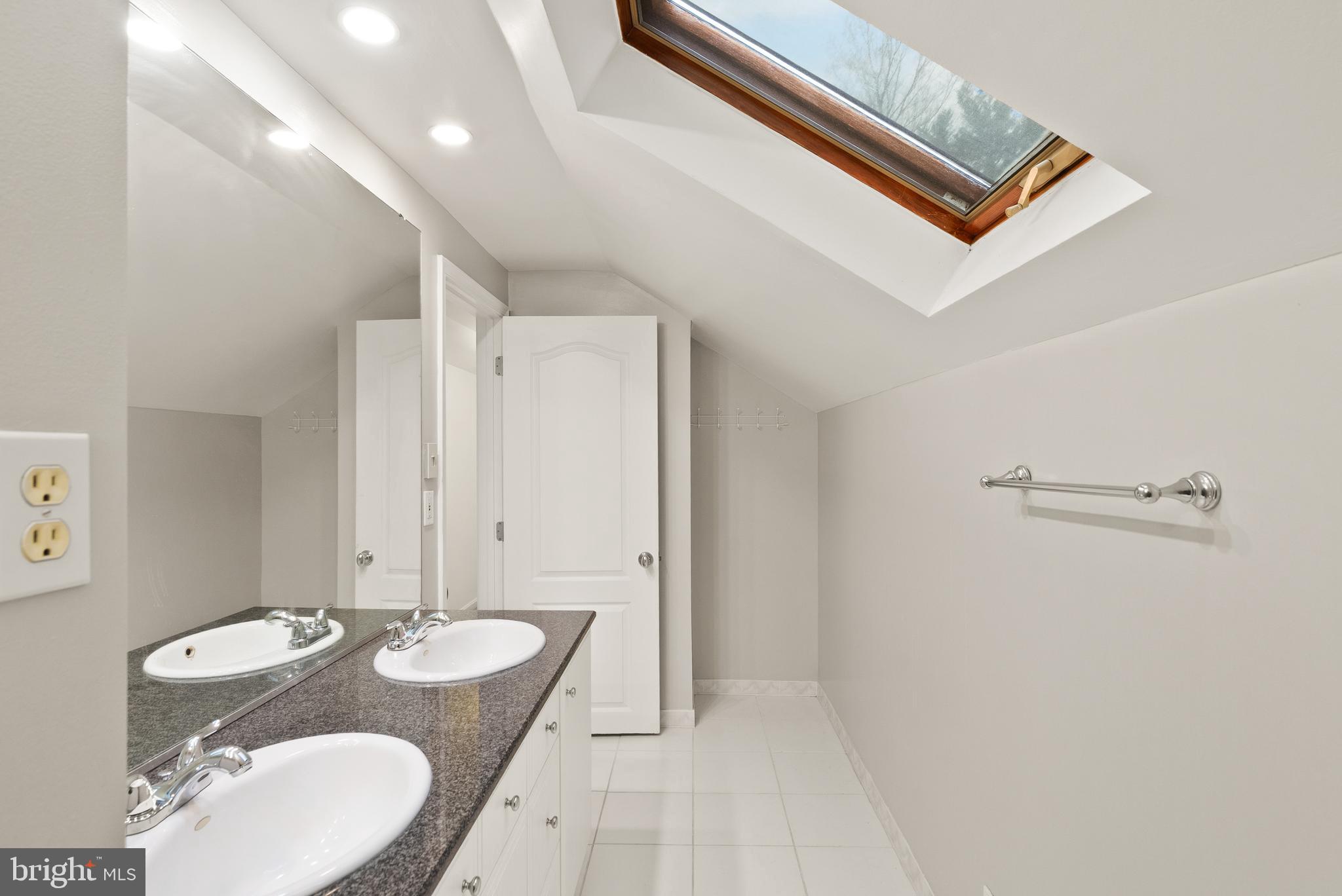 2928 Hunter Road Fairfax, VA 22031 - Photo 48 of 73 a bathroom with a granite countertop sink a mirror and a shower