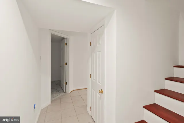 a front view of a house with a yard covered in snow