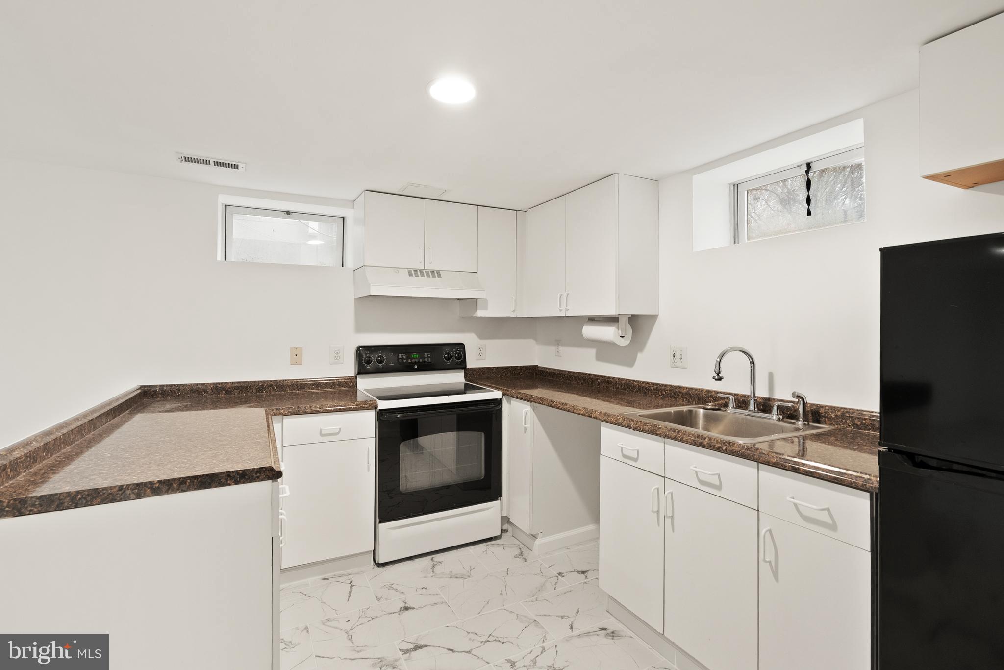 2928 Hunter Road Fairfax, VA 22031 - Photo 53 of 73 a kitchen with granite countertop a sink stove and refrigerator