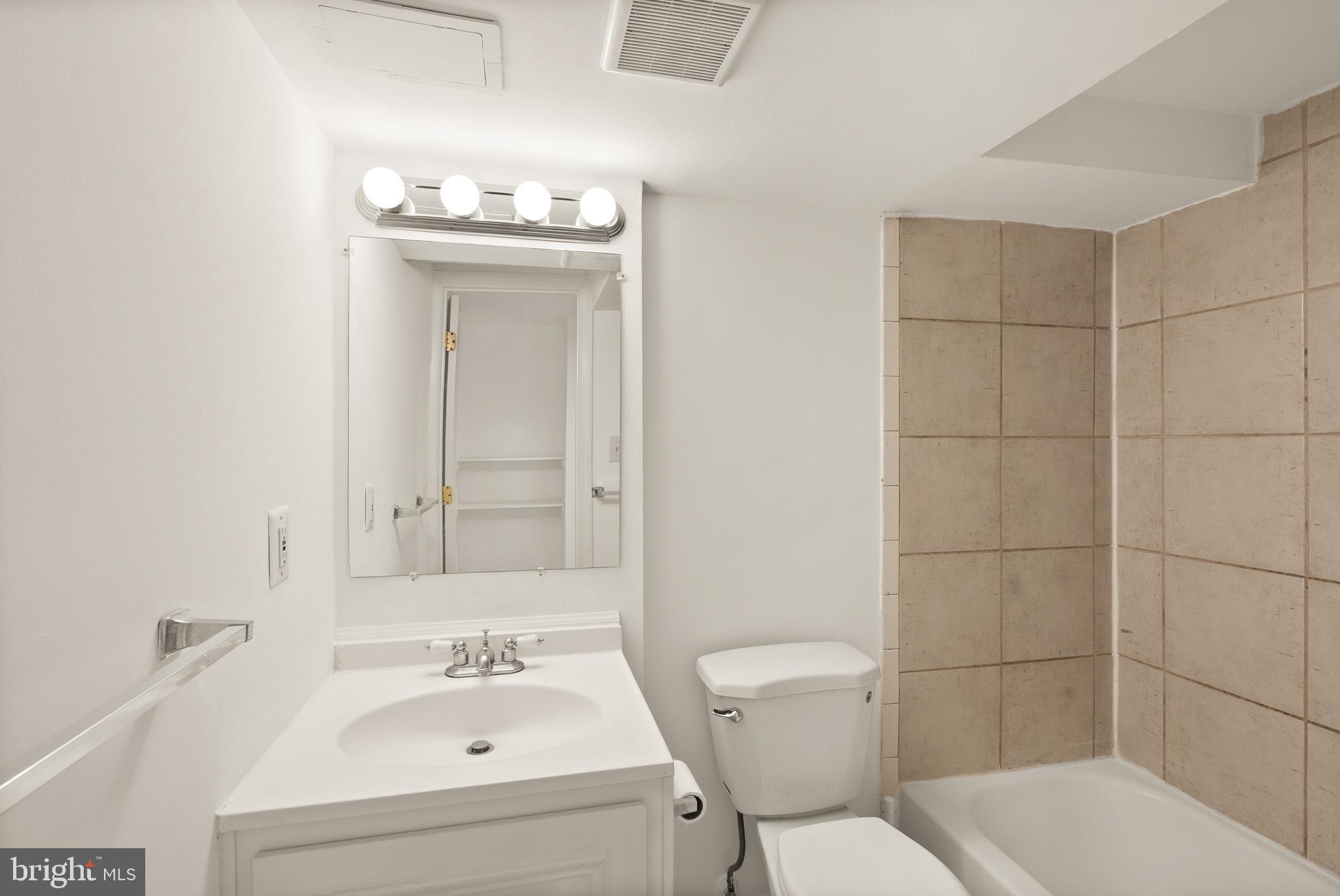 2928 Hunter Road Fairfax, VA 22031 - Photo 60 of 73 a bathroom with a sink a toilet and shower