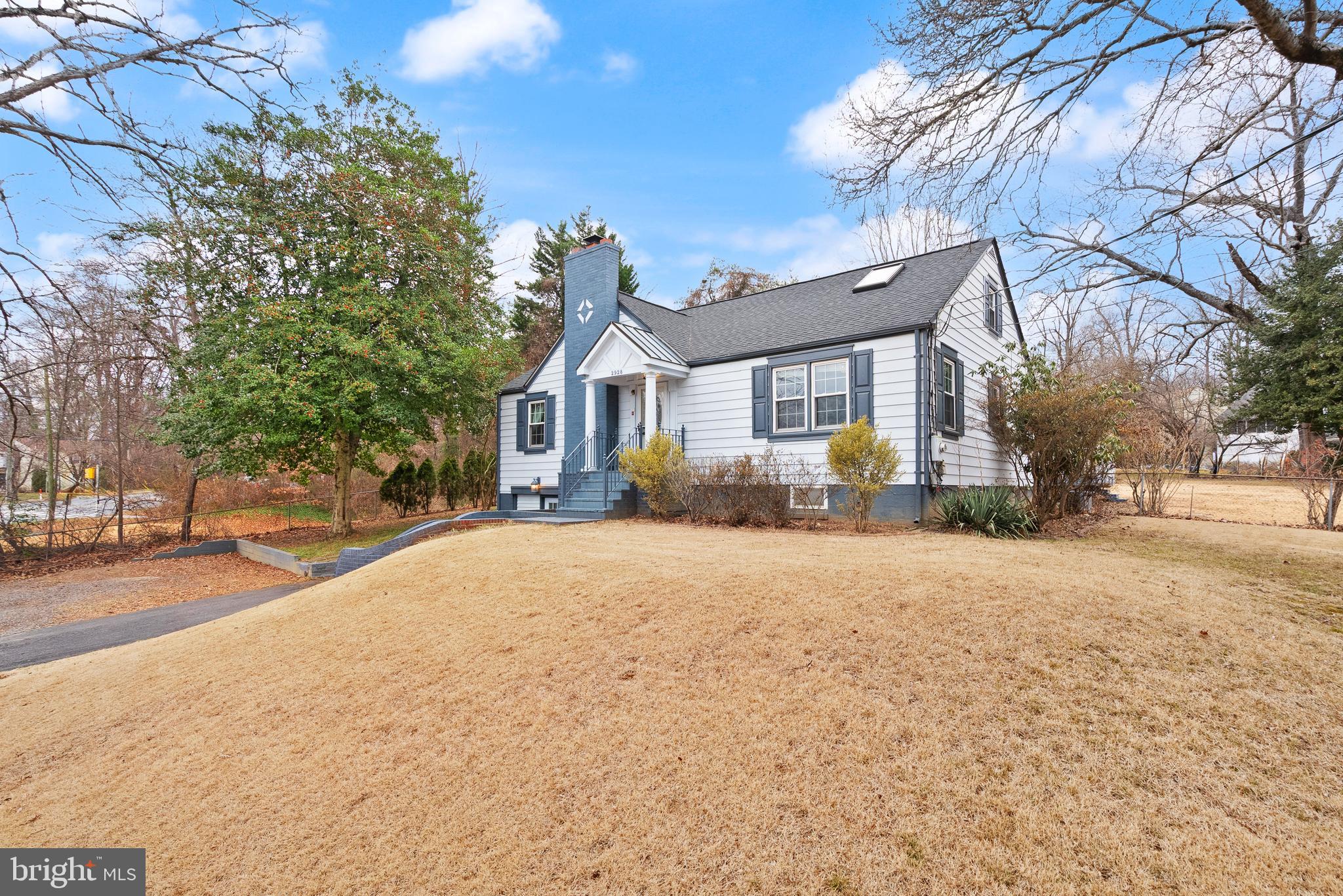 2928 Hunter Road Fairfax, VA 22031 - Photo 6 of 73 a front view of a house with a yard and garage