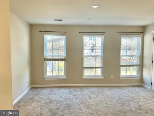 a view of an empty room with windows
