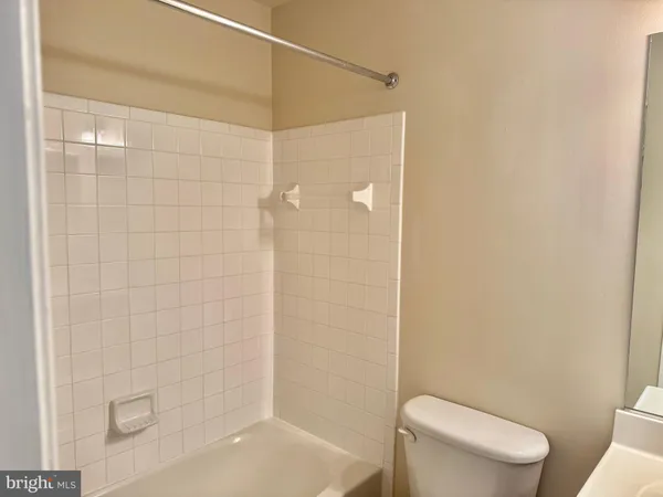 a bathroom with a shower a toilet and sink