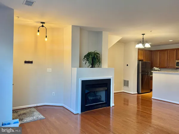 a view of a livingroom with a fireplace and wooden floor