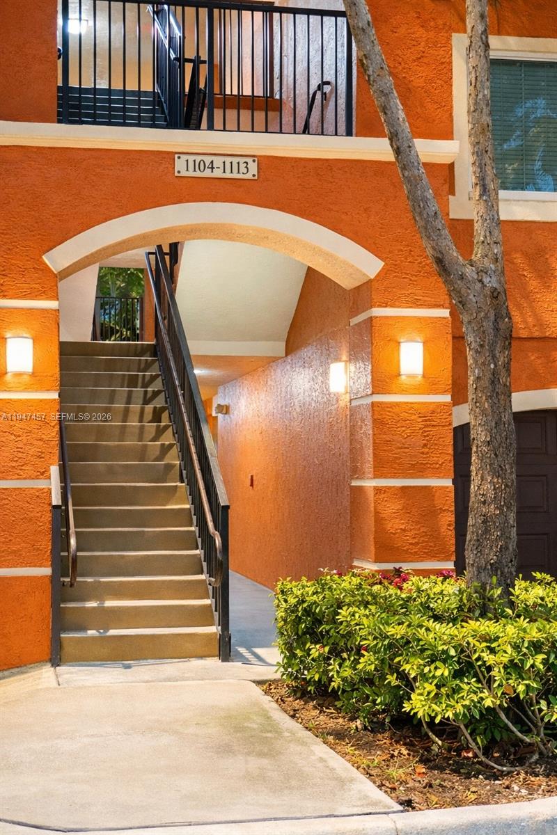 4167 Haverhill Road, Unit 1113 West Palm Beach, FL 33417 - Photo 2 of 18 a view of building with wooden stairs