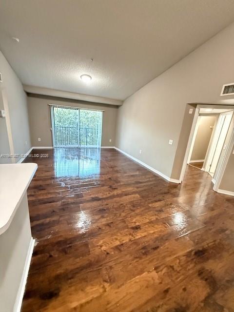 4167 Haverhill Road, Unit 1113 West Palm Beach, FL 33417 - Photo 6 of 18 wooden floor in an empty room with a window