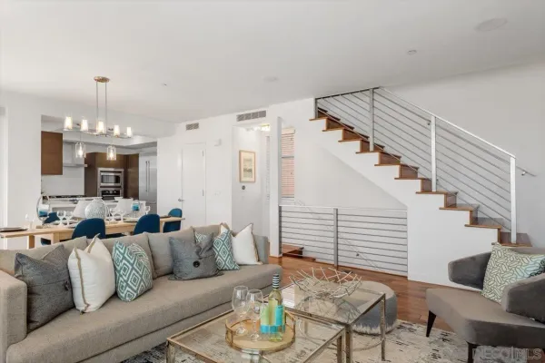 a living room with furniture and a chandelier