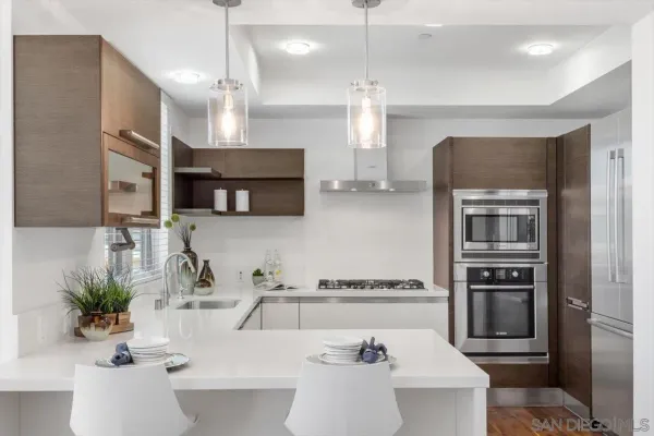 a kitchen with a sink kitchen island and stainless steel appliances