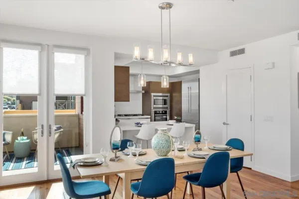 a view of a dining room with furniture wooden floor and chandelier