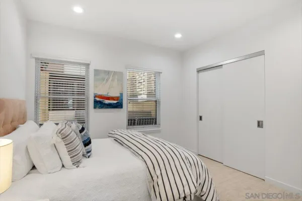 a bedroom with a large bed and a window