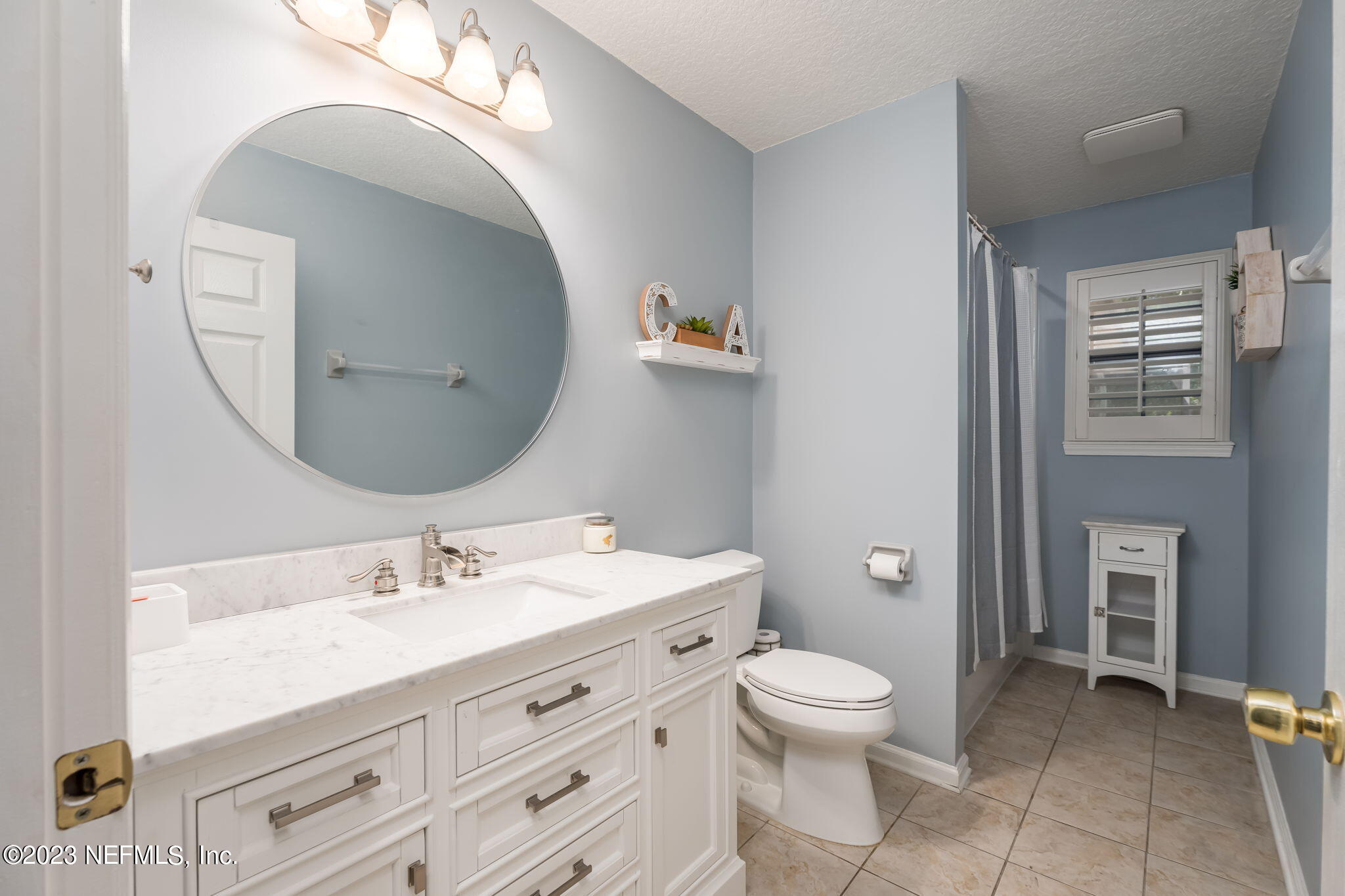 1662 Dockside Drive Fleming Island, FL 32003 - Photo 14 of 18 a bathroom with a toilet a sink and mirror