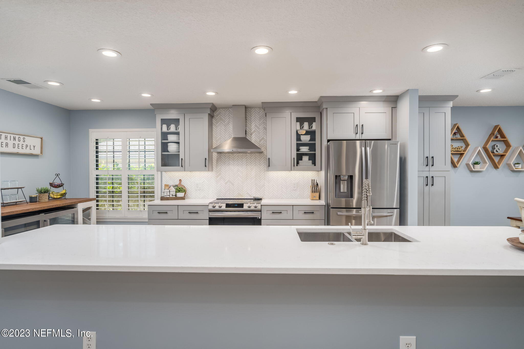 1662 Dockside Drive Fleming Island, FL 32003 - Photo 6 of 18 a kitchen with kitchen island granite countertop a sink and a refrigerator