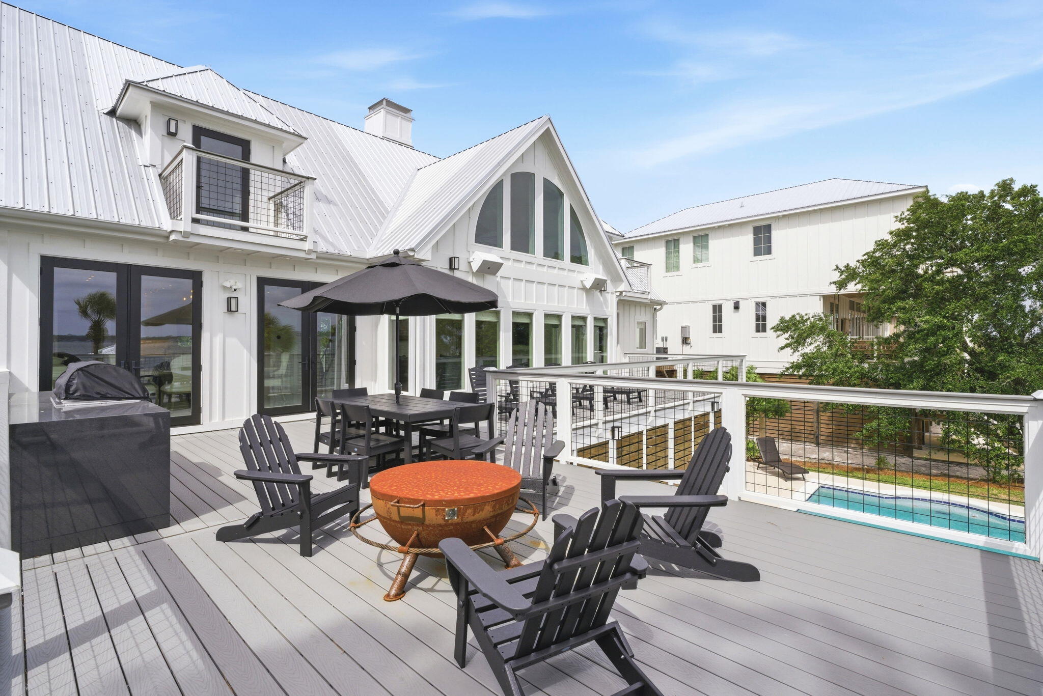 31061 Peninsula Drive Orange Beach, AL 36561 - Photo 24 of 93 a view of a patio with table and chairs with wooden floor and fence