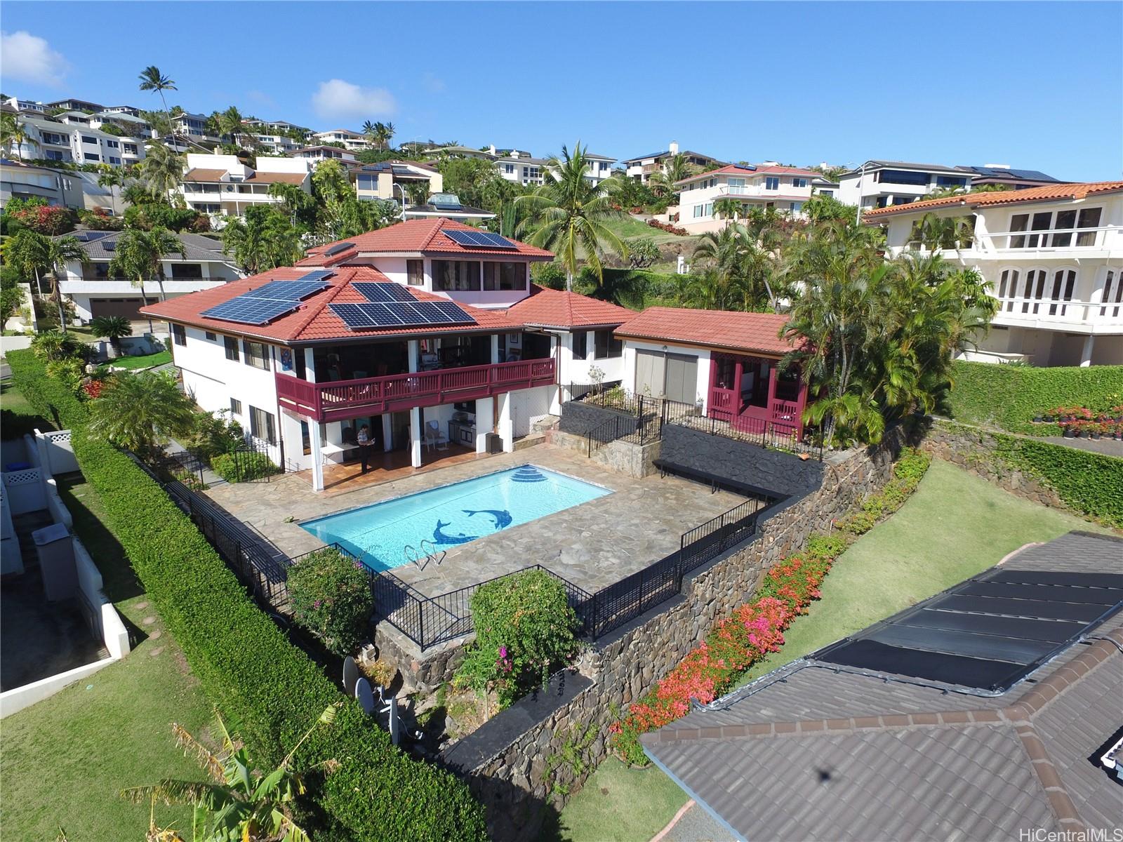 an aerial view of a house with yard and patio