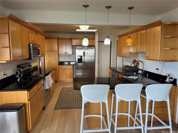 a kitchen with stainless steel appliances granite countertop a sink stove and cabinets