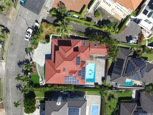 an aerial view of a house with a yard and a fountain