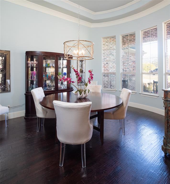 811 Red Store Court Lucas, TX 75002 - Photo 3 of 31 a view of a dining room with furniture wooden floor and chandelier