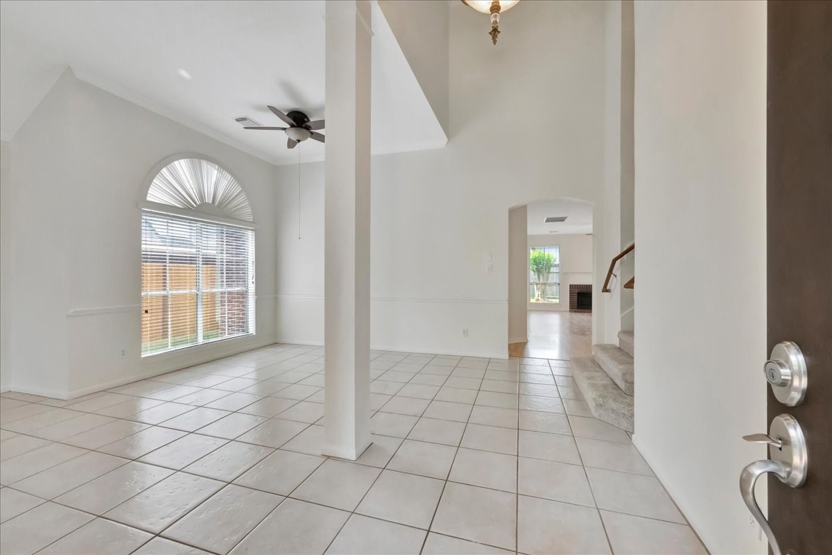 14010 Hazel Ridge Court Houston, TX 77062 - Photo 4 of 38 Welcome inside! To the left, find the formal living room, directly ahead find the formal dining room and through the arched doorway, find the downstairs primary bedroom, family room and kitchen.