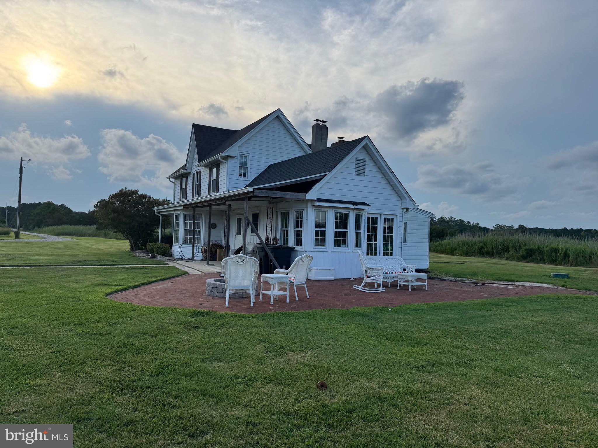 2707 Clara Road Tyaskin, MD 21865 - Photo 7 of 10 a patio with table and chairs with plants and big yard