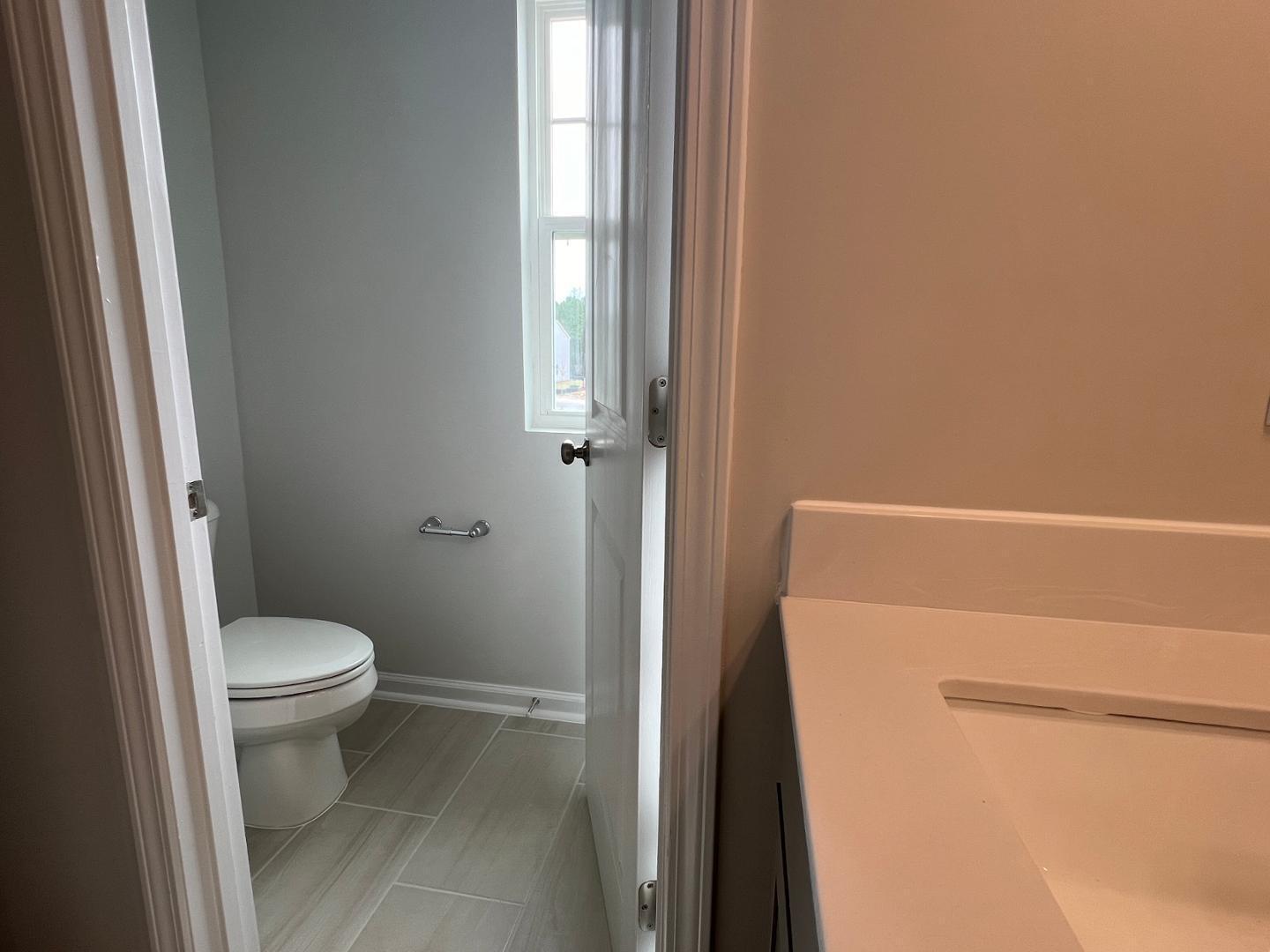 5028 Arkose Drive Raleigh, NC 27610 - Photo 14 of 36 a bathroom with a toilet and a shower