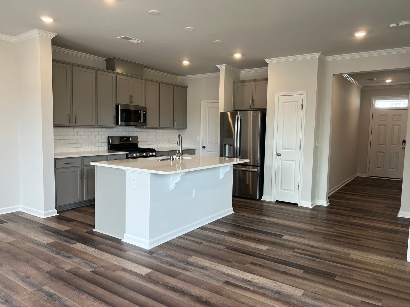 5028 Arkose Drive Raleigh, NC 27610 - Photo 5 of 36 a kitchen with stainless steel appliances a refrigerator stove and sink