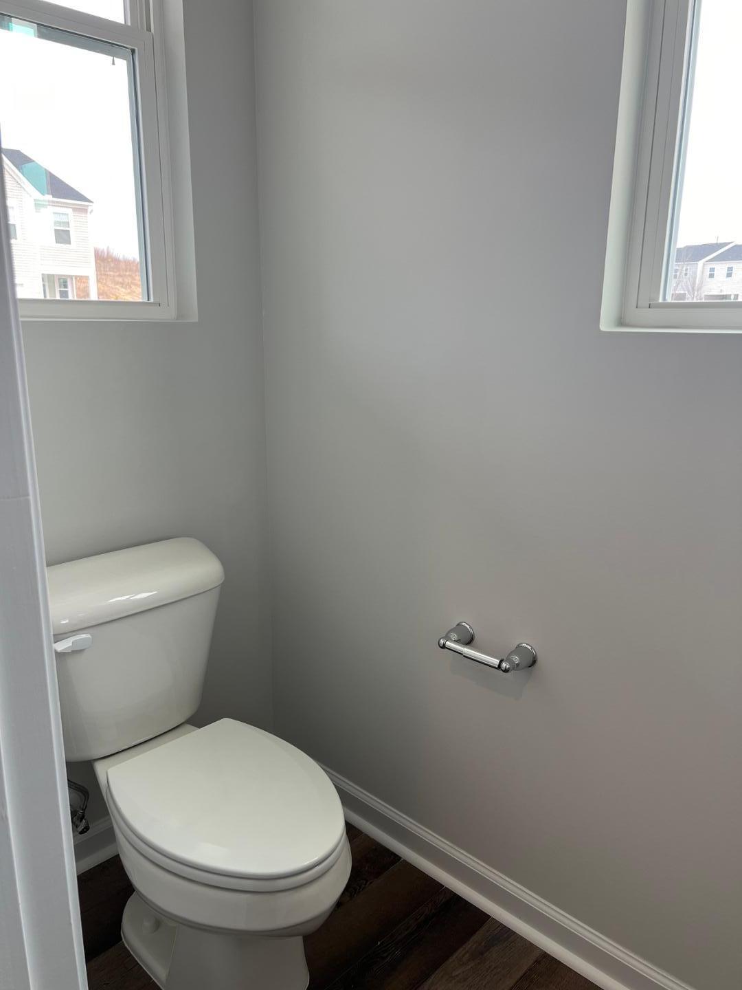 5028 Arkose Drive Raleigh, NC 27610 - Photo 7 of 36 a white toilet sitting in a bathroom next to a window