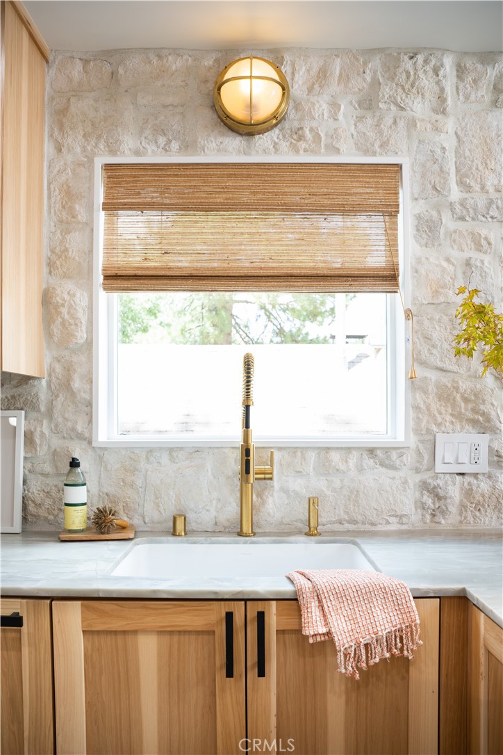 2358 Fir Drive Running Springs, CA 92382 - Photo 11 of 40 a bathroom with a granite countertop sink and a window