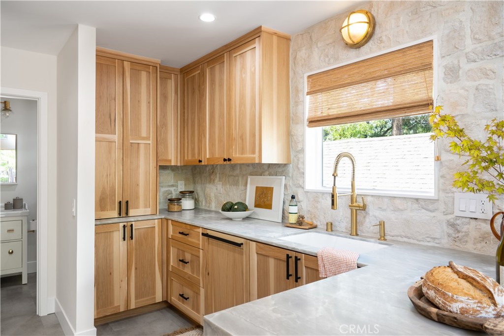 2358 Fir Drive Running Springs, CA 92382 - Photo 10 of 40 a kitchen with stainless steel appliances a sink stove and cabinets