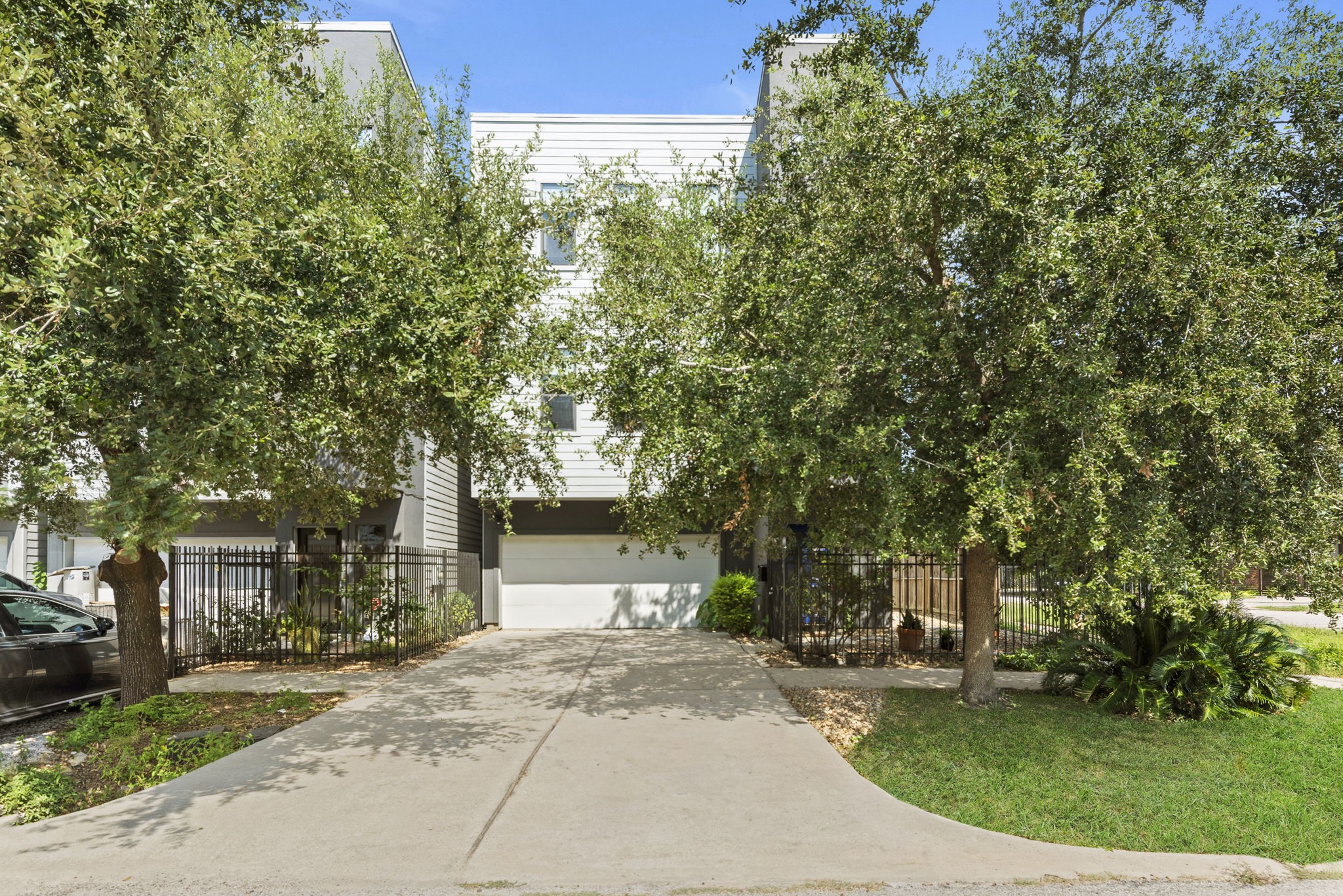 a front view of a house with a yard and trees