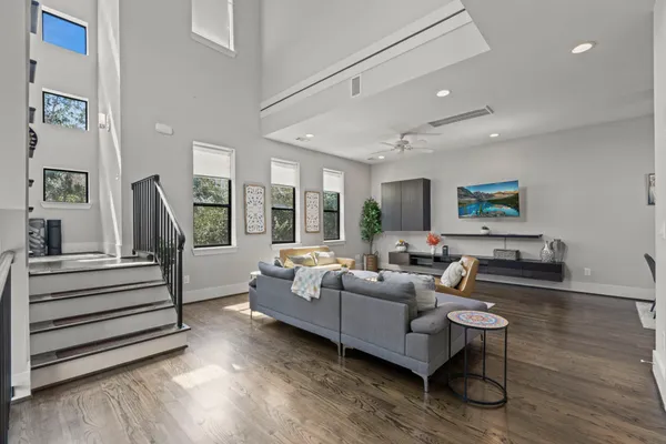 a living room with furniture and a wooden floor