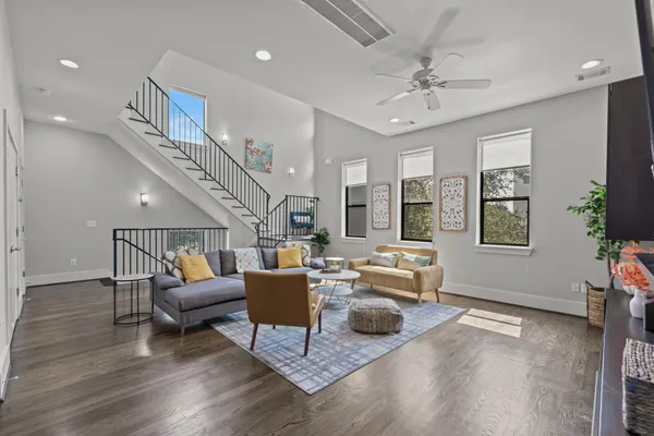 a living room with furniture and wooden floor
