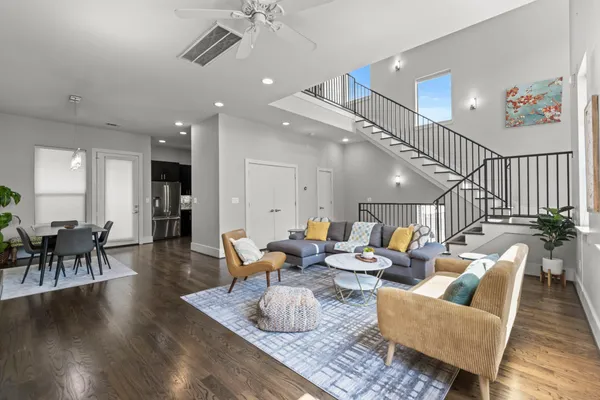 a living room with furniture and wooden floor