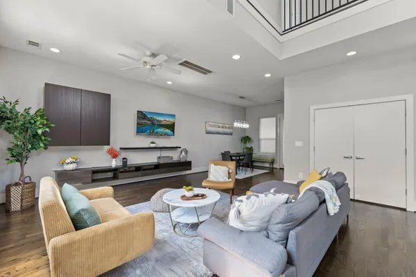 a living room with furniture and wooden floor