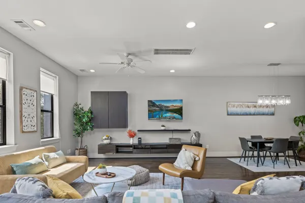 a living room with furniture and wooden floor