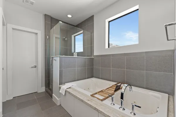 a bathroom with a tub and shower