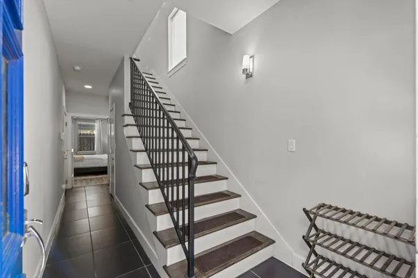 a view of entryway and hall with wooden floor