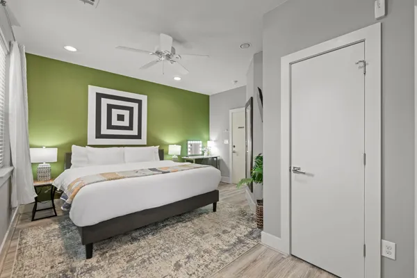 a bedroom with a large bed and a chandelier