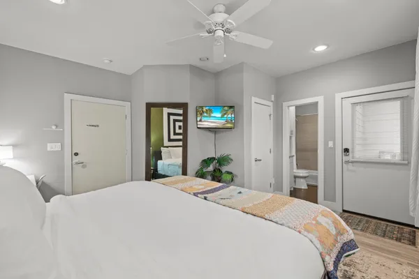 a bedroom with a large bed and chandelier