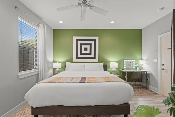 a bedroom with a bed and a chandelier