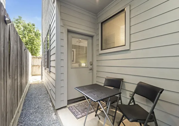 a backyard of a house with table and chairs