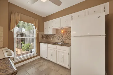a kitchen with stainless steel appliances granite countertop a sink and a refrigerator
