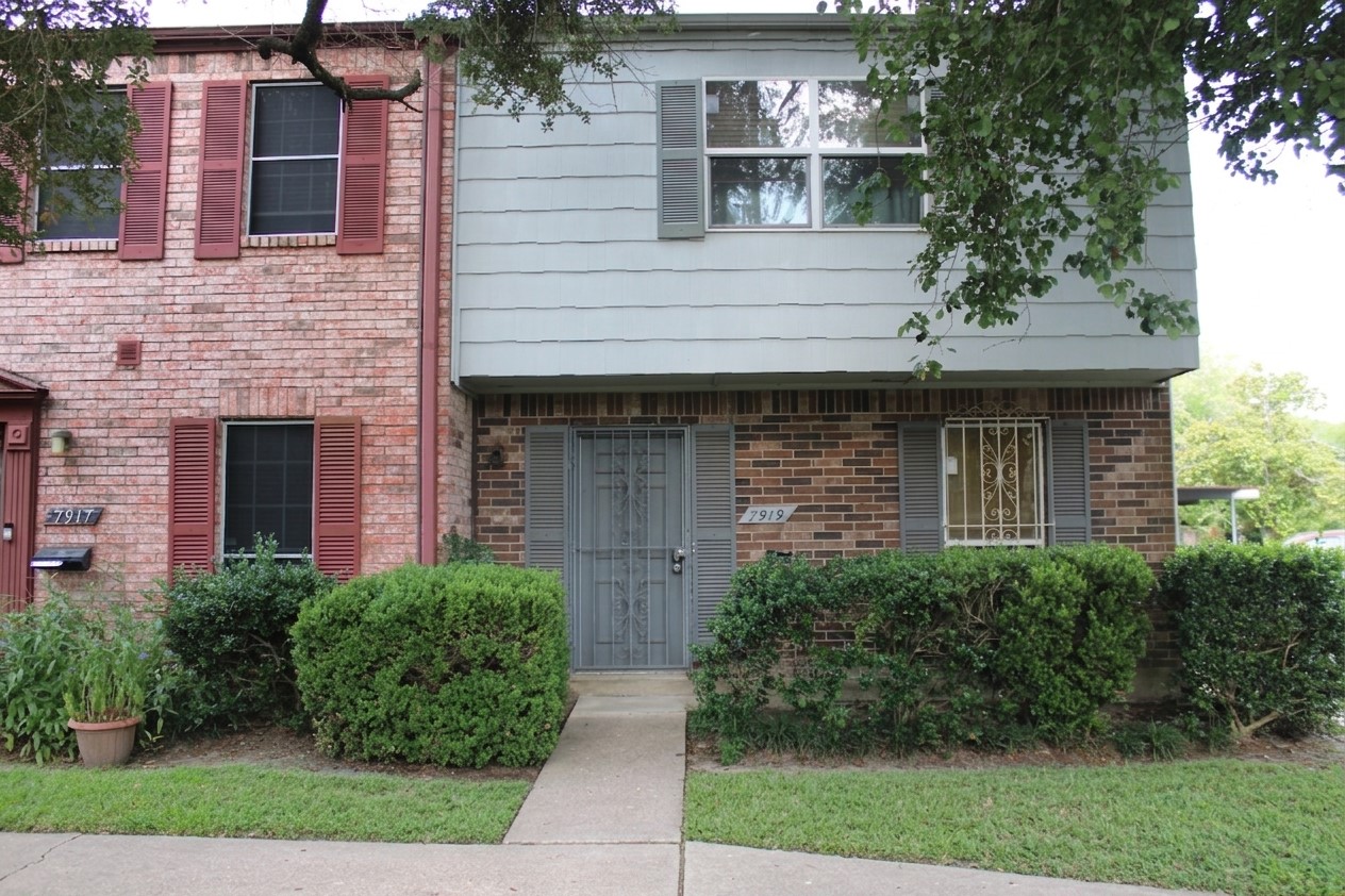 7919 Grove Ridge Drive Houston, TX 77061 - Photo 1 of 9 Charming brick and shake-sided front entry with a decorative security door, manicured shrubs, and a welcoming walkway.
Some photos have been digitally enhanced.