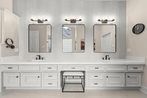 a bathroom with double vanity sink a mirror and vanity