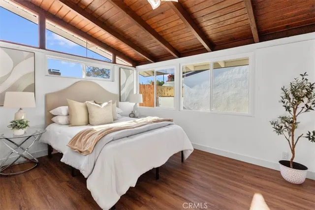 a bedroom with a bed and a potted plant