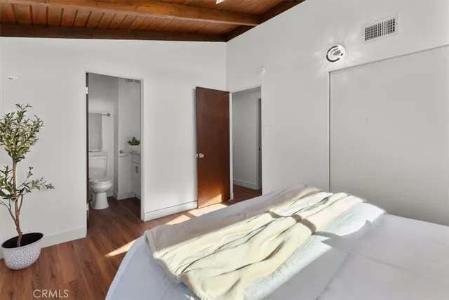 a bedroom with a large bed and a chandelier