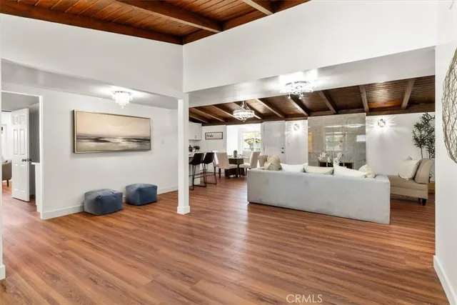 a living room with fireplace furniture and a wooden floor